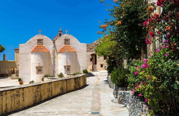 Preveli Monastery in Crete with blooming flowers and the historic church – serene and cultural wedding location