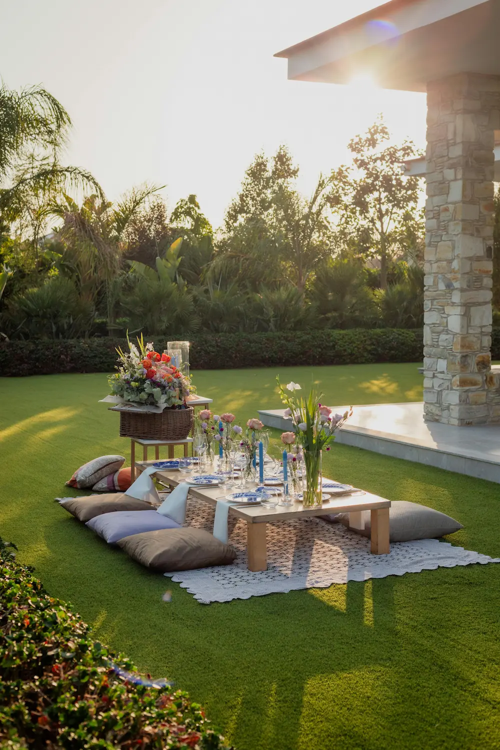 A beautifully styled private picnic setup at a villa in Crete, with decorated tables, florals, and cozy cushions, ready for an intimate gathering — part of Celebrations and Events in Crete.