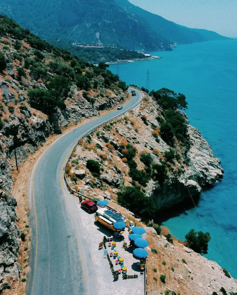 retreats Scenic panoramic view of Crete with winding coastal road, mountains, and sea — symbolizing freedom, discovery, and the heart of Crete Retreats and Curated Experiences.