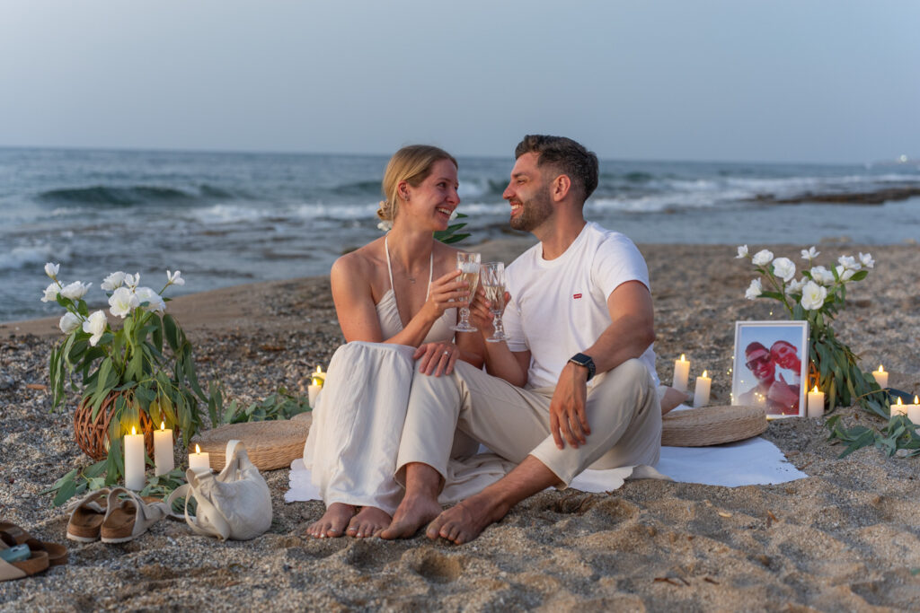 Minimalist sunset beach proposal setup with candles in Rethymno, Crete⁠