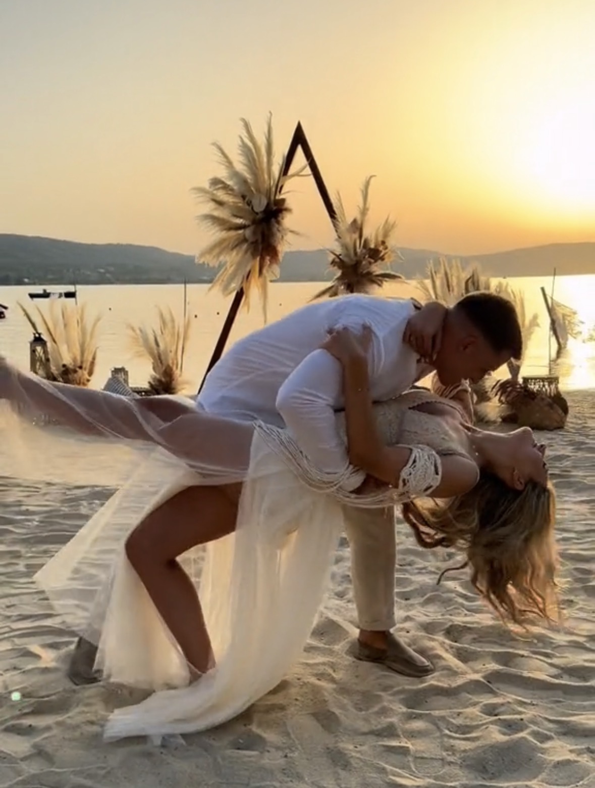 Romantic wedding elopement couple embracing on a sandy beach at sunset in Elounda, Crete, created a by wedspace